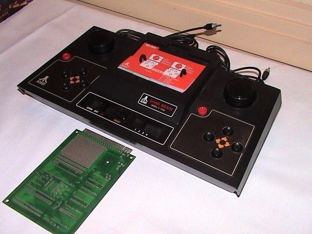 【Atari Game Brain（1977）】1977年，市场中大部分的游戏机都为单一内置游戏设计，无法更换游戏，而Atari Game Brain的出现改变了这种情况。它是第一款真正意义上可以更换媒介的游戏机，但并非是卡带也不可能是光盘，而是一种定制IC电路，昂贵的成本无法在当时的市场中推广，并没有真正上市。